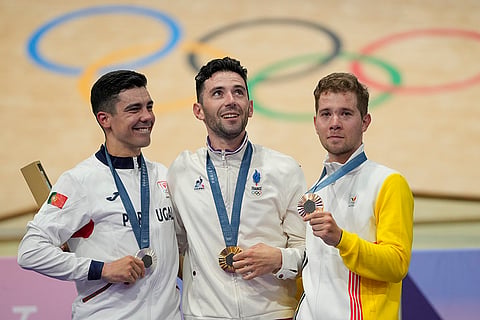 Paris Olympics Track Cycling men's omnium event: Benjamin Thomas of France, centre, (gold) with Iuri Leitao of Portugal (silver), left, and Fabio van den Bossche of Belgium (bronze)